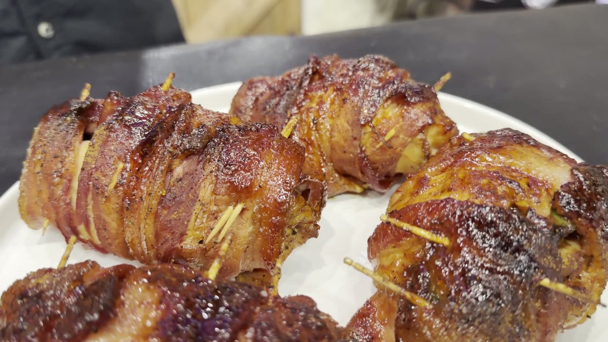 Texas Thunder Thighs: bacon wrapped stuffed chicken thighs glazed with BBQ sauce on a white plate