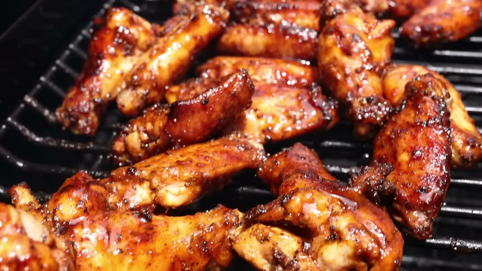 Glazed hot BBQ chicken wings finishing on the Traeger grill grates